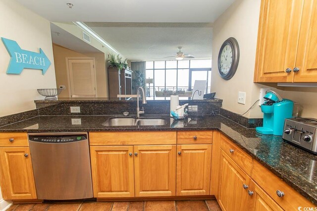 100 N Beach Blvd Unit 1801, North Myrtle Beach, SC 29582 - kitchen with stainless steel dishwasher, a ceiling fan, a toaster, a sink, and dark stone countertops