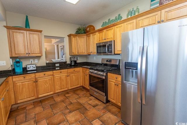100 N Beach Blvd Unit 1801, North Myrtle Beach, SC 29582 - kitchen with dark stone counters, appliances with stainless steel finishes, and stone finish floor