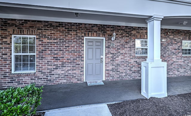 property entrance featuring brick siding