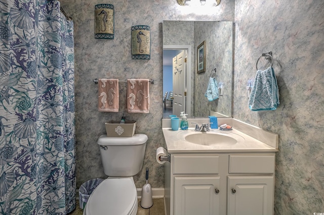 full bathroom featuring toilet, vanity, and a shower with shower curtain