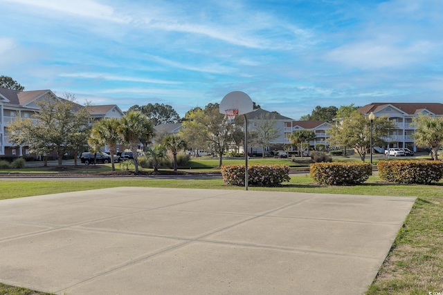 surrounding community featuring a residential view, a yard, and community basketball court