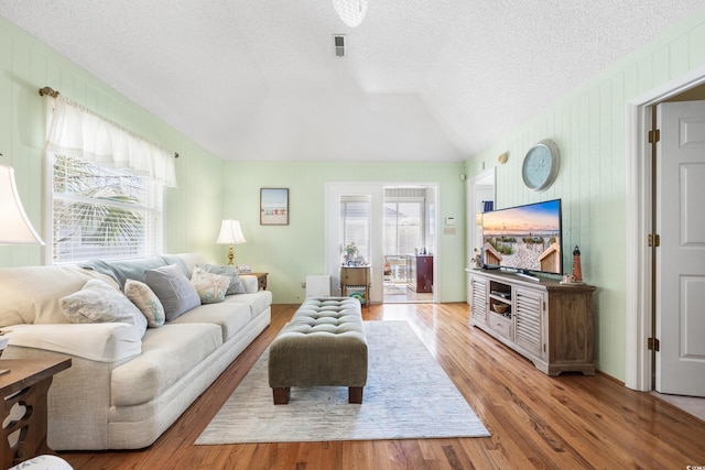 820 9th Ave S, North Myrtle Beach, SC 29582 - living area with wood finished floors, vaulted ceiling, and a textured ceiling