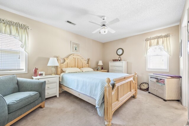 820 9th Ave S, North Myrtle Beach, SC 29582 - bedroom with light carpet, a ceiling fan, and a textured ceiling