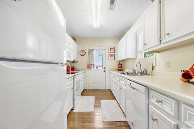 820 9th Ave S, North Myrtle Beach, SC 29582 - kitchen featuring white appliances, a sink, wood finished floors, a textured ceiling, and light countertops