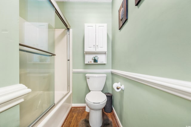 820 9th Ave S, North Myrtle Beach, SC 29582 - full bath with wood finished floors, baseboards, toilet, and combined bath / shower with glass door
