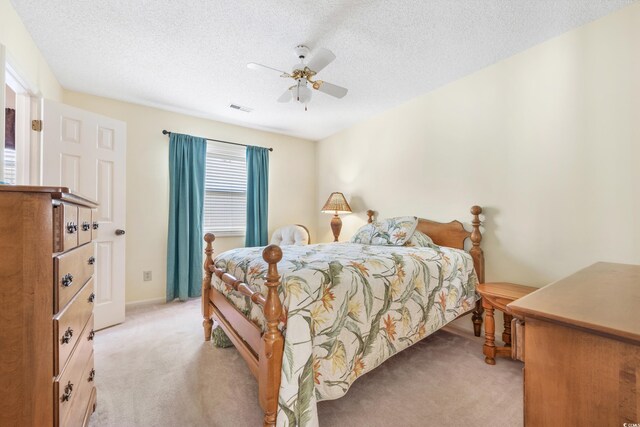 820 9th Ave S, North Myrtle Beach, SC 29582 - bedroom with light carpet, a textured ceiling, ceiling fan, and baseboards