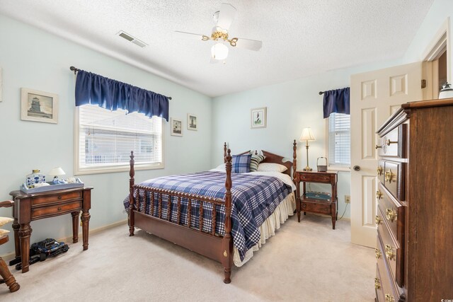 820 9th Ave S, North Myrtle Beach, SC 29582 - bedroom featuring light carpet, a textured ceiling, and ceiling fan
