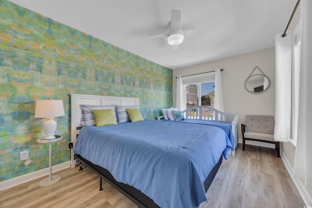 800 9th Ave S Unit A-4, North Myrtle Beach, SC 29582 - bedroom with baseboards, ceiling fan, light wood-type flooring, and wallpapered walls