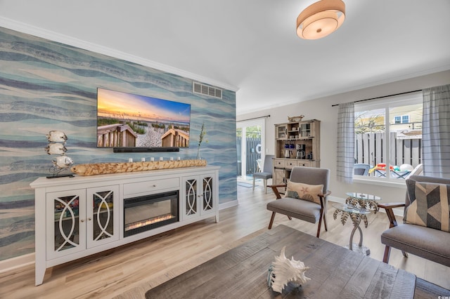 800 9th Ave S Unit A-4, North Myrtle Beach, SC 29582 - living room featuring baseboards, ornamental molding, wood finished floors, and visible vents