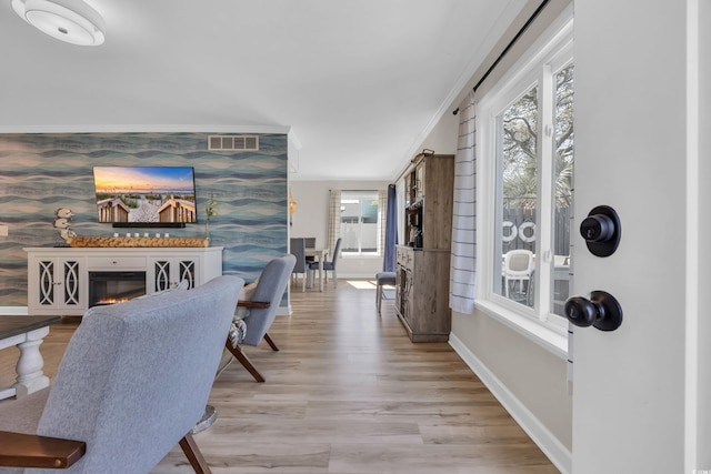 800 9th Ave S Unit A-4, North Myrtle Beach, SC 29582 - hallway with light wood-type flooring, an accent wall, baseboards, and ornamental molding