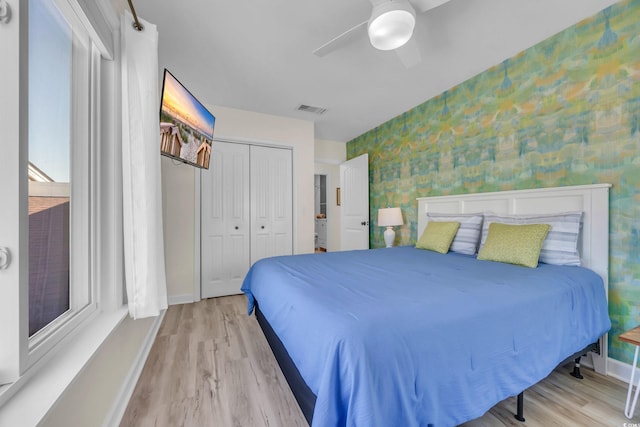 800 9th Ave S Unit A-4, North Myrtle Beach, SC 29582 - bedroom with wallpapered walls, wood finished floors, baseboards, a closet, and ceiling fan