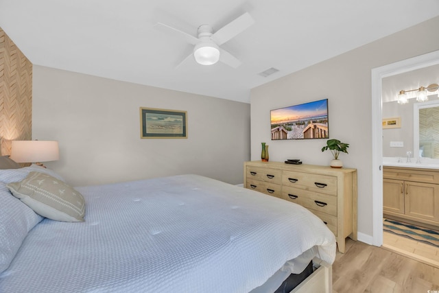 800 9th Ave S Unit A-4, North Myrtle Beach, SC 29582 - bedroom with visible vents, a ceiling fan, a sink, light wood finished floors, and ensuite bath