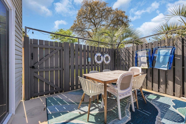 800 9th Ave S Unit A-4, North Myrtle Beach, SC 29582 - view of patio / terrace featuring fence, outdoor dining area, and a gate