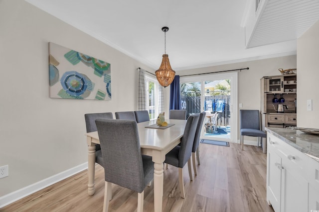 800 9th Ave S Unit A-4, North Myrtle Beach, SC 29582 - dining area featuring crown molding, baseboards, and light wood-style flooring