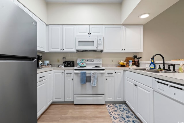 102 Scotch Broom Dr Unit B-302, Little River, SC 29566 - kitchen with white cabinetry, white appliances, light countertops, and a sink