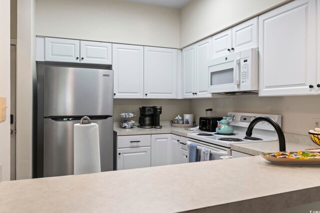 102 Scotch Broom Dr Unit B-302, Little River, SC 29566 - kitchen with light countertops, white cabinets, and white appliances