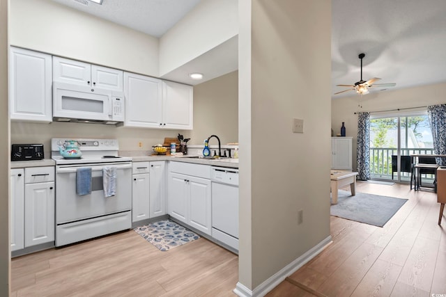 102 Scotch Broom Dr Unit B-302, Little River, SC 29566 - kitchen with white cabinets, white appliances, light wood-style flooring, and a sink