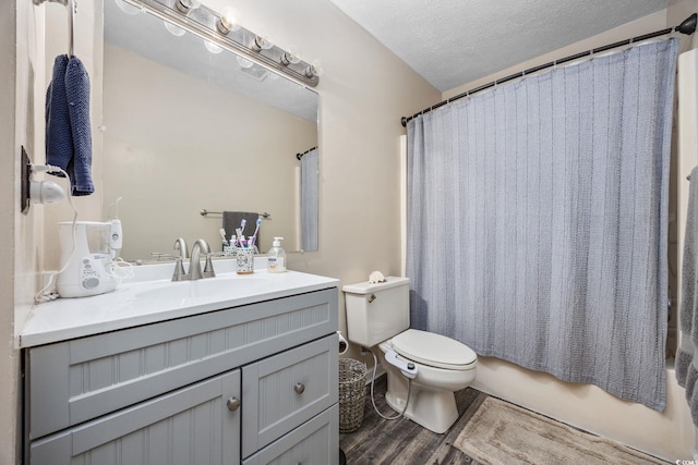 706 Birch Ln, Conway, SC 29526 - bathroom with toilet, wood finished floors, vanity, a textured ceiling, and shower / bathtub combination with curtain