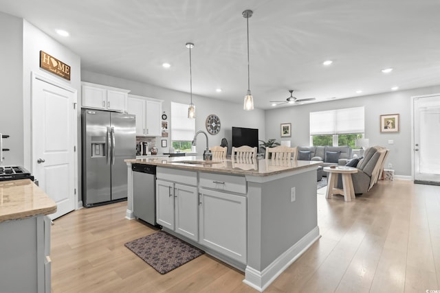 239 Calhoun Falls Dr, Myrtle Beach, SC 29579 - kitchen featuring appliances with stainless steel finishes, a sink, white cabinets, open floor plan, and a ceiling fan