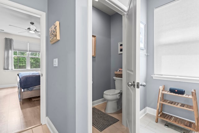 239 Calhoun Falls Dr, Myrtle Beach, SC 29579 - bathroom with toilet, connected bathroom, a ceiling fan, baseboards, and wood finished floors