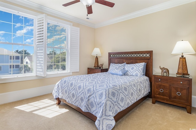 bedroom with carpet flooring, crown molding, visible vents, and baseboards