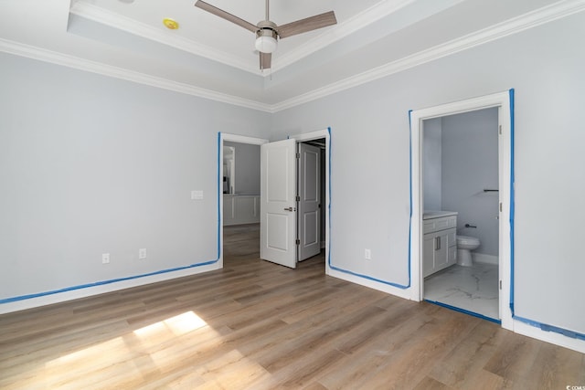 1500 Sunmeadow Dr, Conway, SC 29526 - unfurnished bedroom with a tray ceiling, baseboards, ornamental molding, light wood-style flooring, and ensuite bath