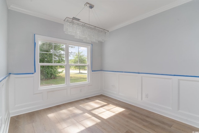 1500 Sunmeadow Dr, Conway, SC 29526 - unfurnished dining area with a chandelier, a decorative wall, light wood finished floors, crown molding, and a wainscoted wall