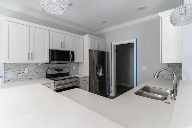 1500 Sunmeadow Dr, Conway, SC 29526 - kitchen with appliances with stainless steel finishes, a sink, white cabinets, backsplash, and crown molding