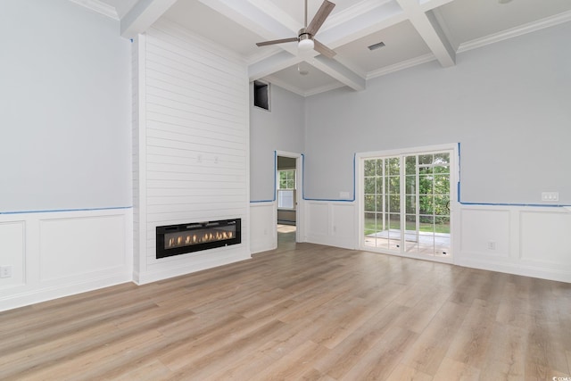 1500 Sunmeadow Dr, Conway, SC 29526 - unfurnished living room featuring beamed ceiling, a decorative wall, ceiling fan, a large fireplace, and light wood-style flooring