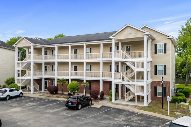 1058 Sea Mountain Hwy Unit 5-301, North Myrtle Beach, SC 29582 - view of building exterior featuring uncovered parking and stairs