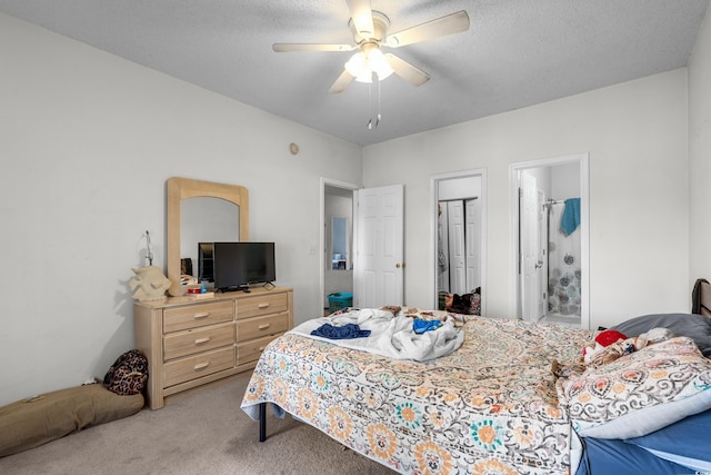 1058 Sea Mountain Hwy Unit 5-301, North Myrtle Beach, SC 29582 - bedroom with light carpet, a textured ceiling, a ceiling fan, a closet, and ensuite bath
