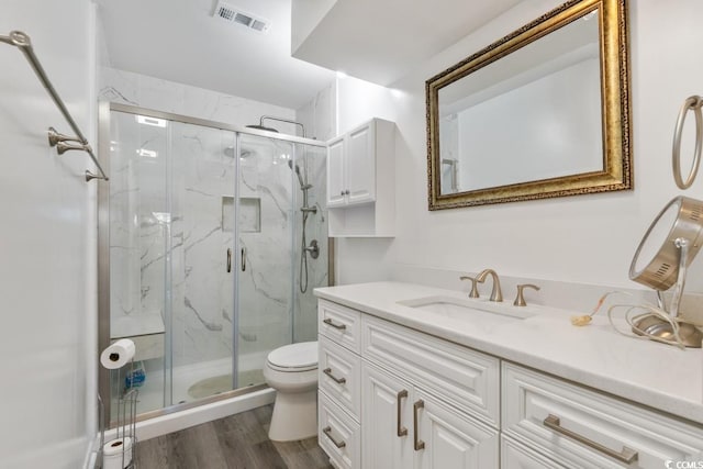 201 N Hillside Dr N Unit 307, North Myrtle Beach, SC 29582 - full bathroom with a marble finish shower, toilet, visible vents, wood finished floors, and vanity