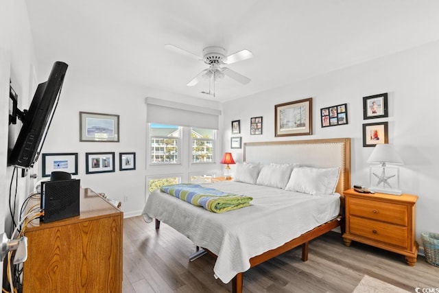 201 N Hillside Dr N Unit 307, North Myrtle Beach, SC 29582 - bedroom featuring baseboards, a ceiling fan, and wood finished floors