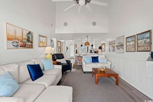 201 N Hillside Dr N Unit 307, North Myrtle Beach, SC 29582 - living room featuring a ceiling fan, a towering ceiling, and dark wood finished floors
