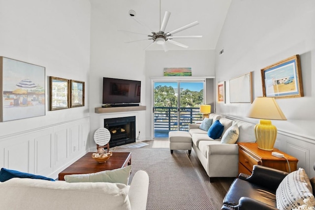 201 N Hillside Dr N Unit 307, North Myrtle Beach, SC 29582 - living room featuring a fireplace with flush hearth, visible vents, a ceiling fan, wood finished floors, and high vaulted ceiling