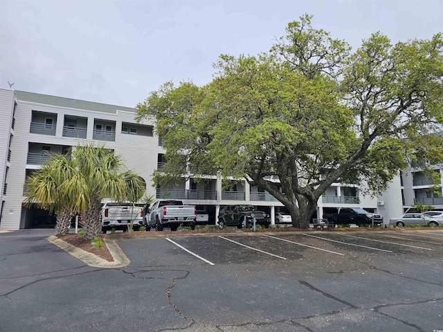 201 N Hillside Dr N Unit 307, North Myrtle Beach, SC 29582 - view of building exterior with uncovered parking