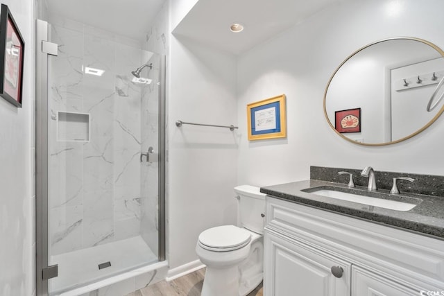 201 N Hillside Dr N Unit 307, North Myrtle Beach, SC 29582 - bathroom featuring wood finished floors, a marble finish shower, vanity, baseboards, and toilet