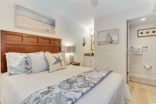 bedroom featuring ceiling fan, ensuite bath, baseboards, light wood-style floors, and recessed lighting
