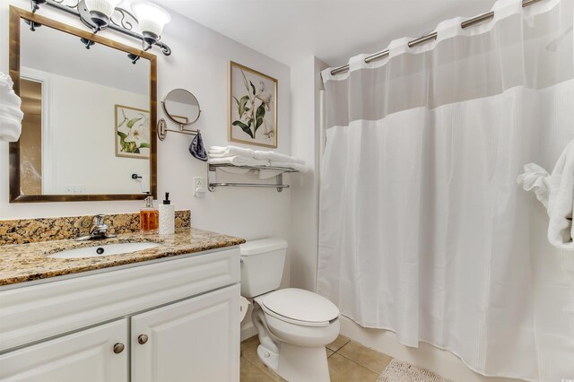 bathroom featuring toilet, shower / tub combo with curtain, tile patterned flooring, and vanity