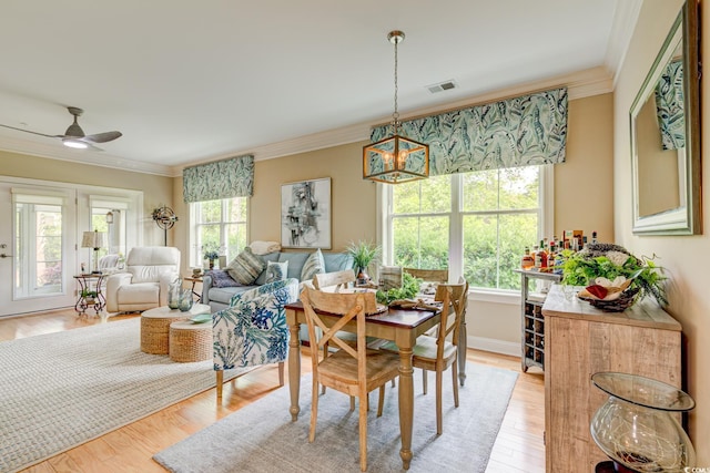 128 Puffin Dr Unit 1-E, Pawleys Island, SC 29585 - dining area featuring ornamental molding, a ceiling fan, and light wood-style flooring