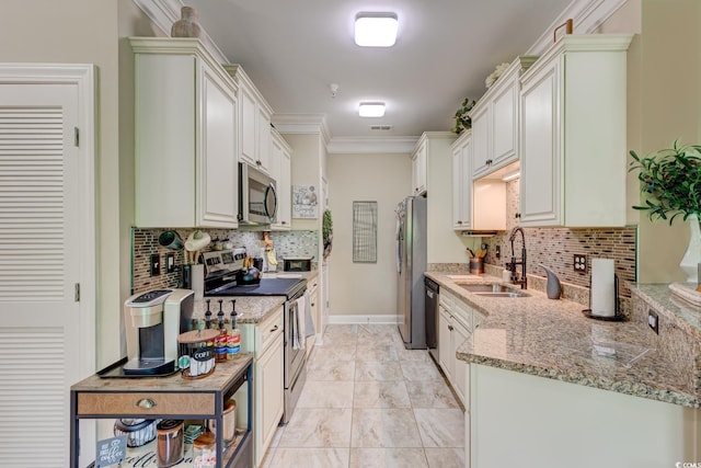 128 Puffin Dr Unit 1-E, Pawleys Island, SC 29585 - kitchen with appliances with stainless steel finishes, tasteful backsplash, light stone countertops, and crown molding