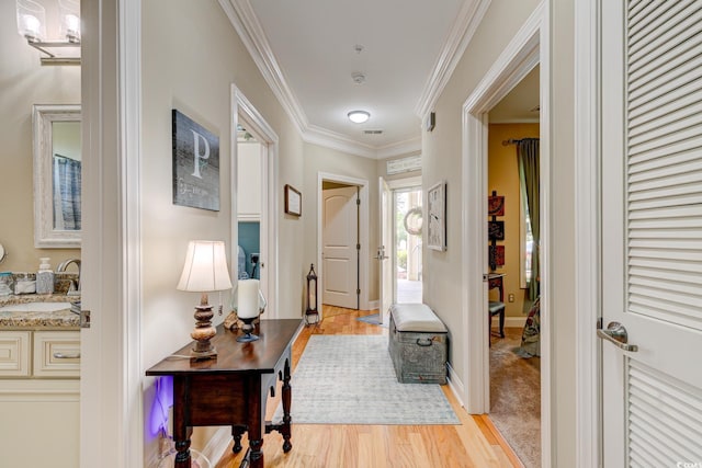128 Puffin Dr Unit 1-E, Pawleys Island, SC 29585 - entrance foyer with light wood-style flooring and crown molding