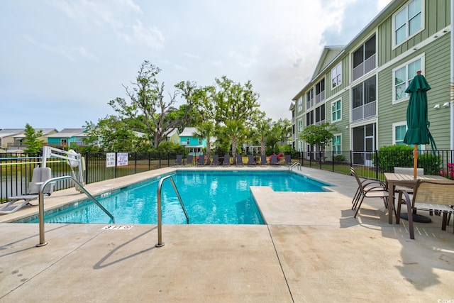 128 Puffin Dr Unit 1-E, Pawleys Island, SC 29585 - community pool featuring a patio