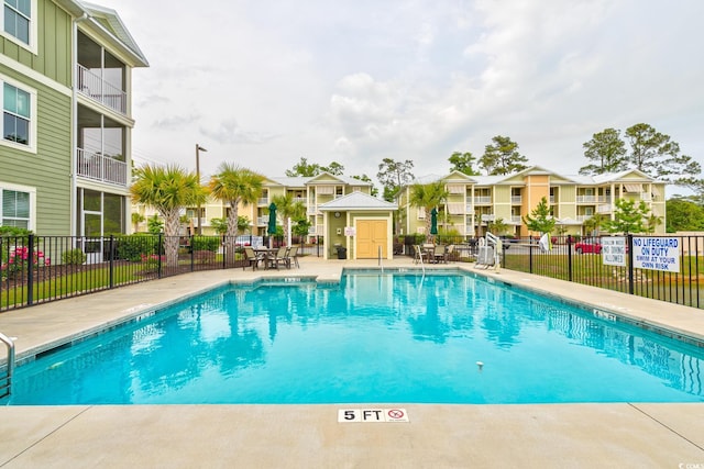 128 Puffin Dr Unit 1-E, Pawleys Island, SC 29585 - community pool with a residential view