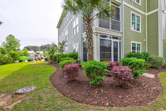 128 Puffin Dr Unit 1-E, Pawleys Island, SC 29585 - view of side of home with board and batten siding and a lawn