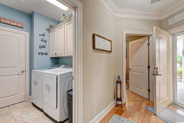 128 Puffin Dr Unit 1-E, Pawleys Island, SC 29585 - laundry area with cabinet space, separate washer and dryer, ornamental molding, and light wood-style flooring