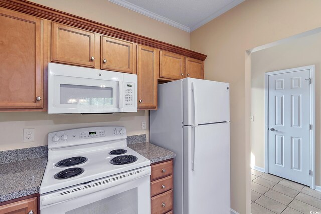 148 Scotch Broom Dr Unit 201, Little River, SC 29566 - kitchen featuring white appliances, light tile patterned floors, crown molding, and brown cabinets