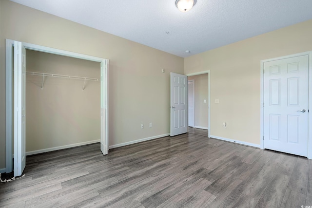 148 Scotch Broom Dr Unit 201, Little River, SC 29566 - unfurnished bedroom with wood finished floors, a closet, and baseboards