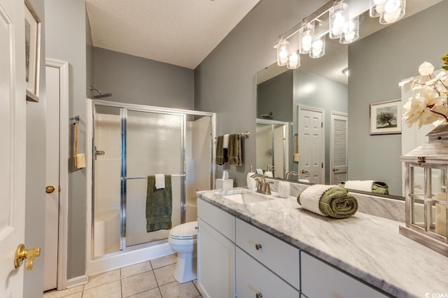 bathroom featuring a shower stall, vanity, toilet, and tile patterned flooring