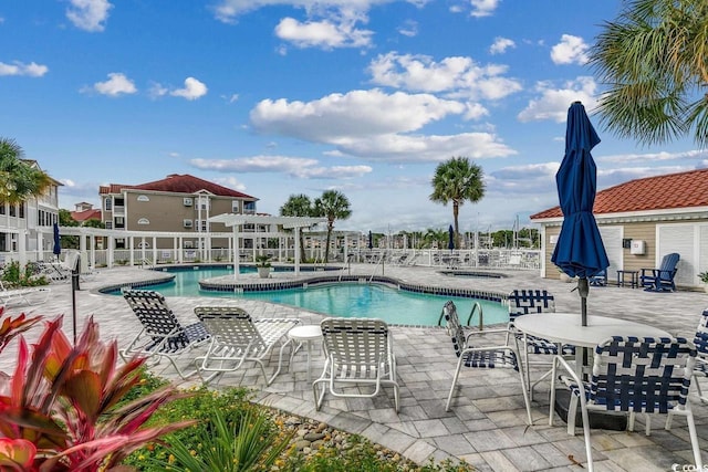 community pool featuring a pergola, fence, and a patio area